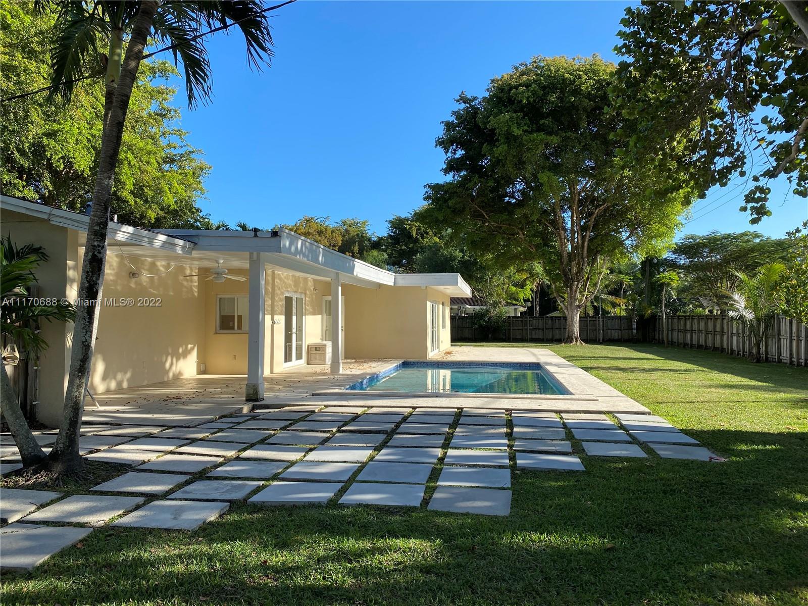 9800 Southwest 70th Avenue Pinecrest, FL 33156 - Photo 3 of 8 a view of backyard with swimming pool and patio
