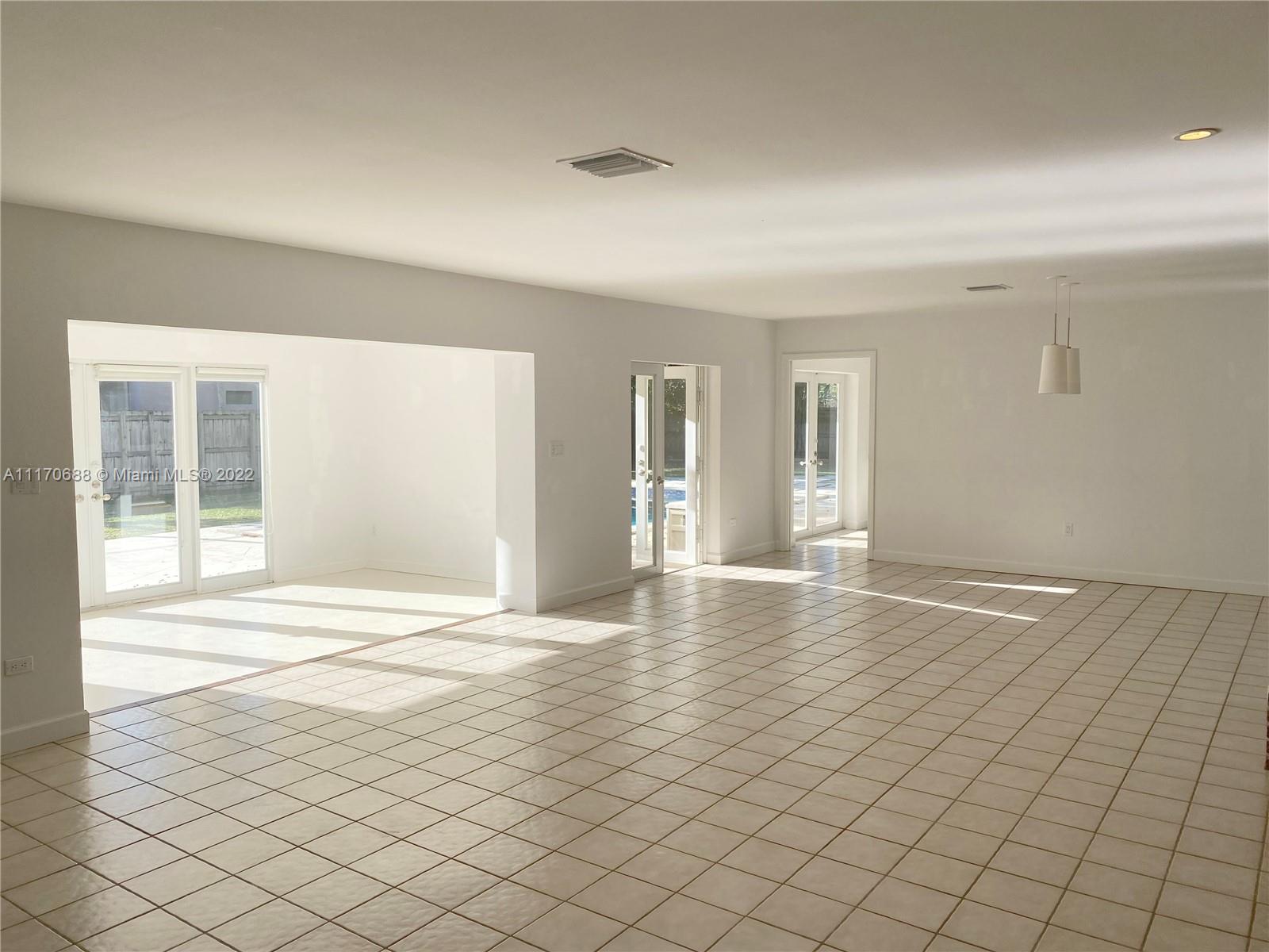 9800 Southwest 70th Avenue Pinecrest, FL 33156 - Photo 4 of 8 a view of an empty room and window