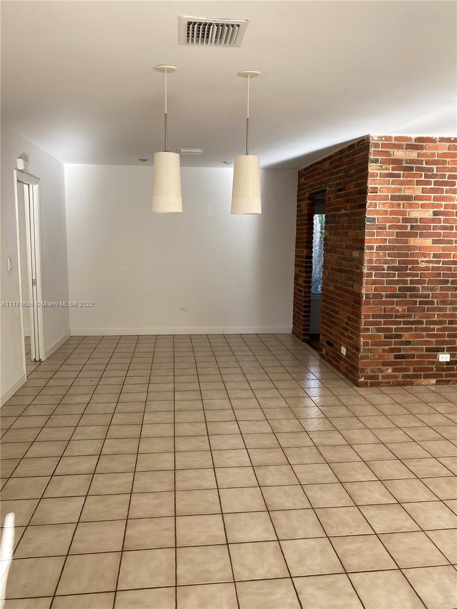 9800 Southwest 70th Avenue Pinecrest, FL 33156 - Photo 5 of 8 a view of an empty room and window