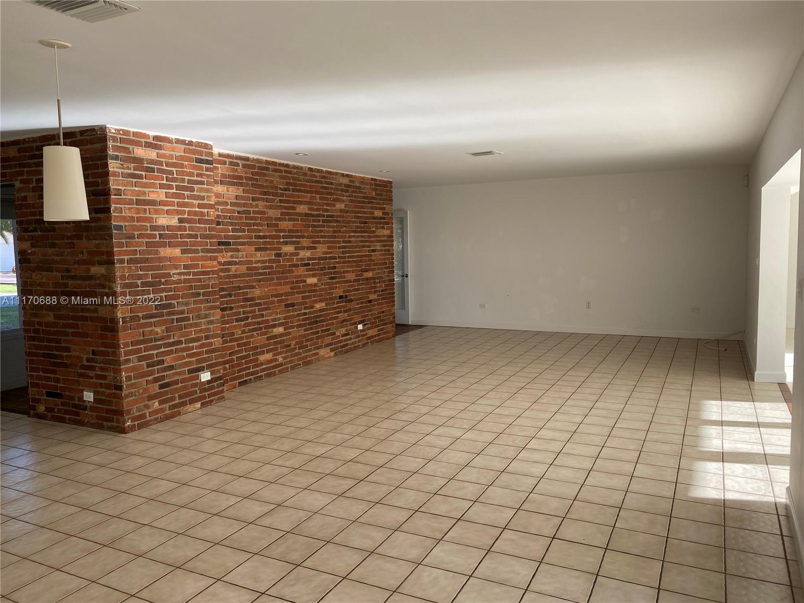 9800 Southwest 70th Avenue Pinecrest, FL 33156 - Photo 7 of 8 a view of an empty room and wooden floor