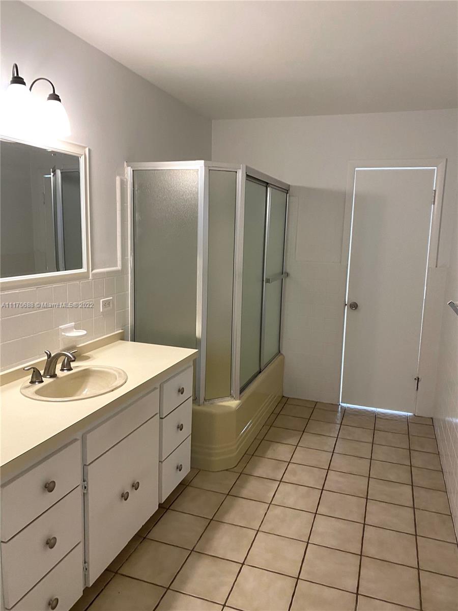 9800 Southwest 70th Avenue Pinecrest, FL 33156 - Photo 8 of 8 a spacious bathroom with a double vanity sink a mirror and a shower