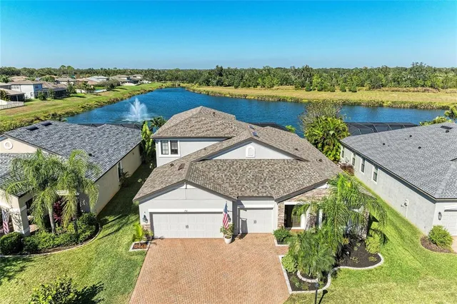 an aerial view of a house with a lake view