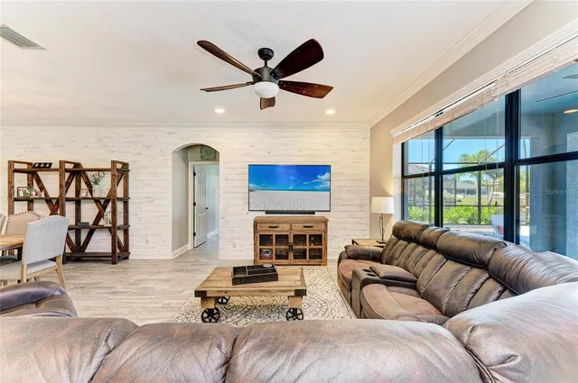 a living room with furniture and kitchen view