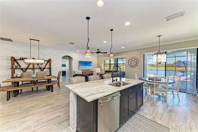 a bathroom with a granite countertop sink mirror and shower