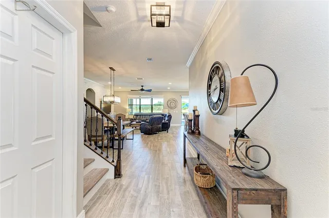 a living room with furniture a rug and white walls