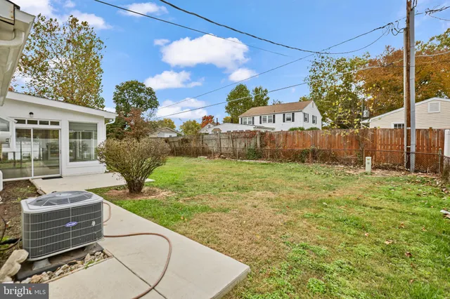 a view of a house with backyard and a tree