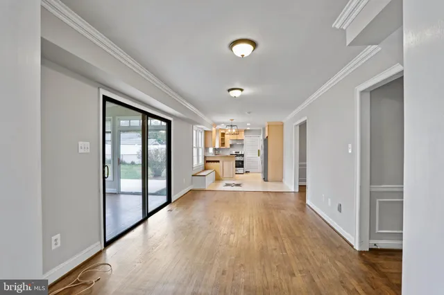 a big room with wooden floor and windows