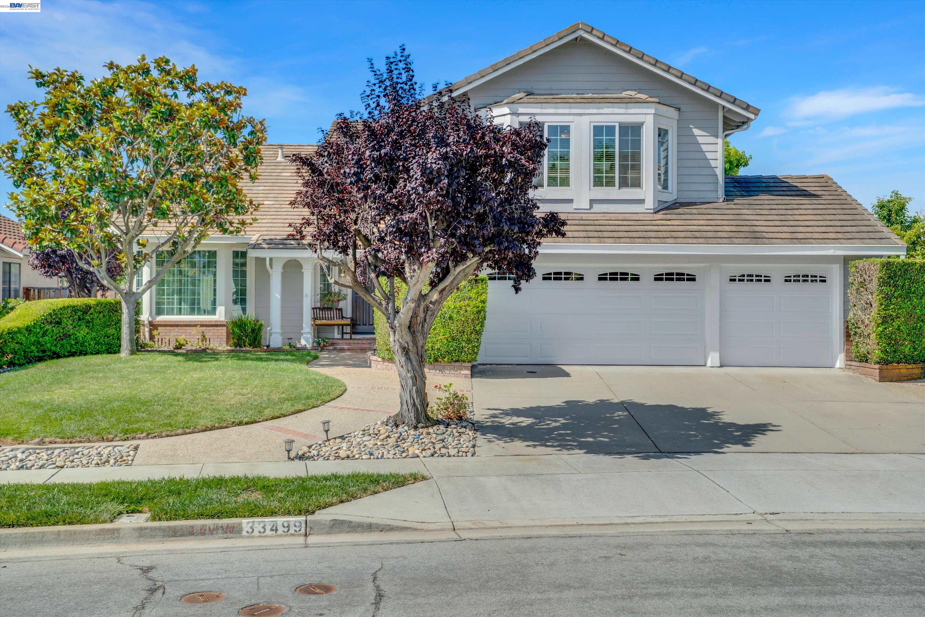 33499 Quail Run Road Fremont, CA 94555 - Photo 1 of 1 a front view of a house with a garden