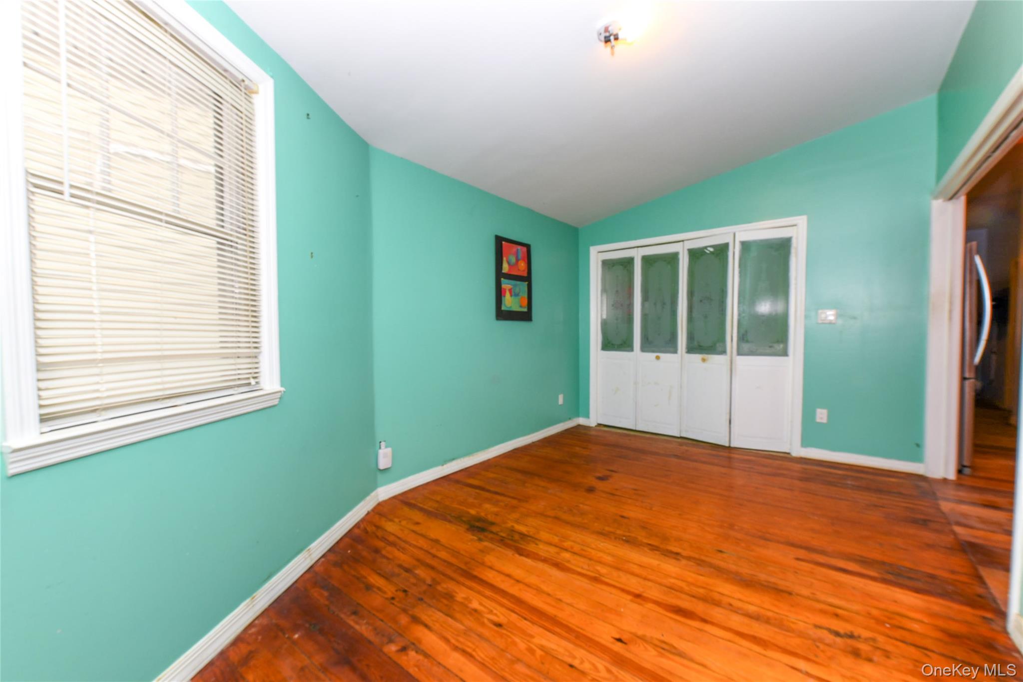 76-43 85th Road Queens, NY 11421 - Photo 13 of 31 a view of a room with window and stairs
