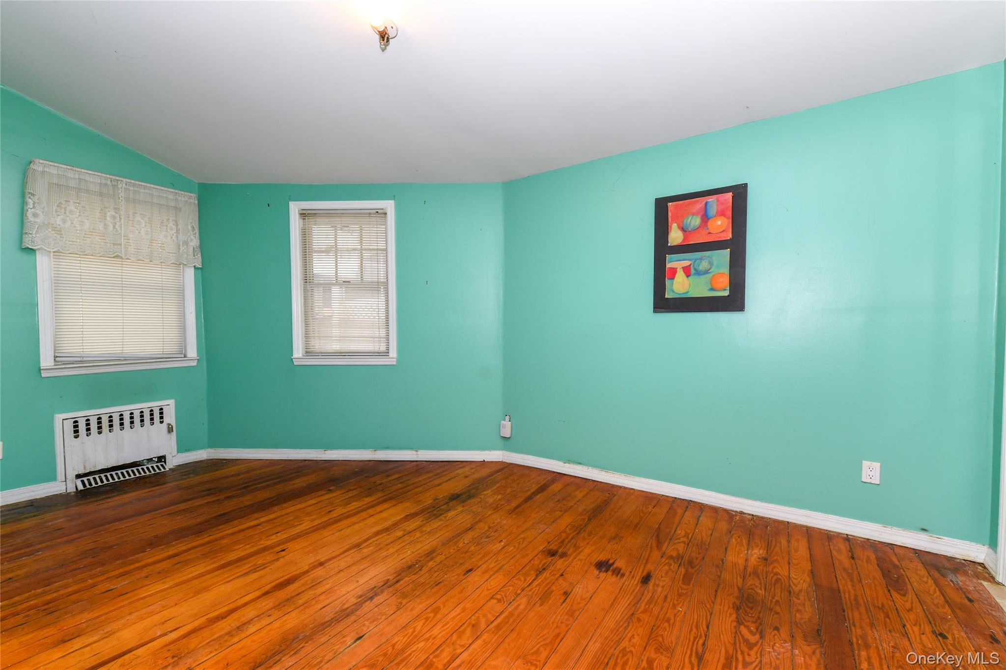 76-43 85th Road Queens, NY 11421 - Photo 14 of 31 a view of a room with wooden floor and a window