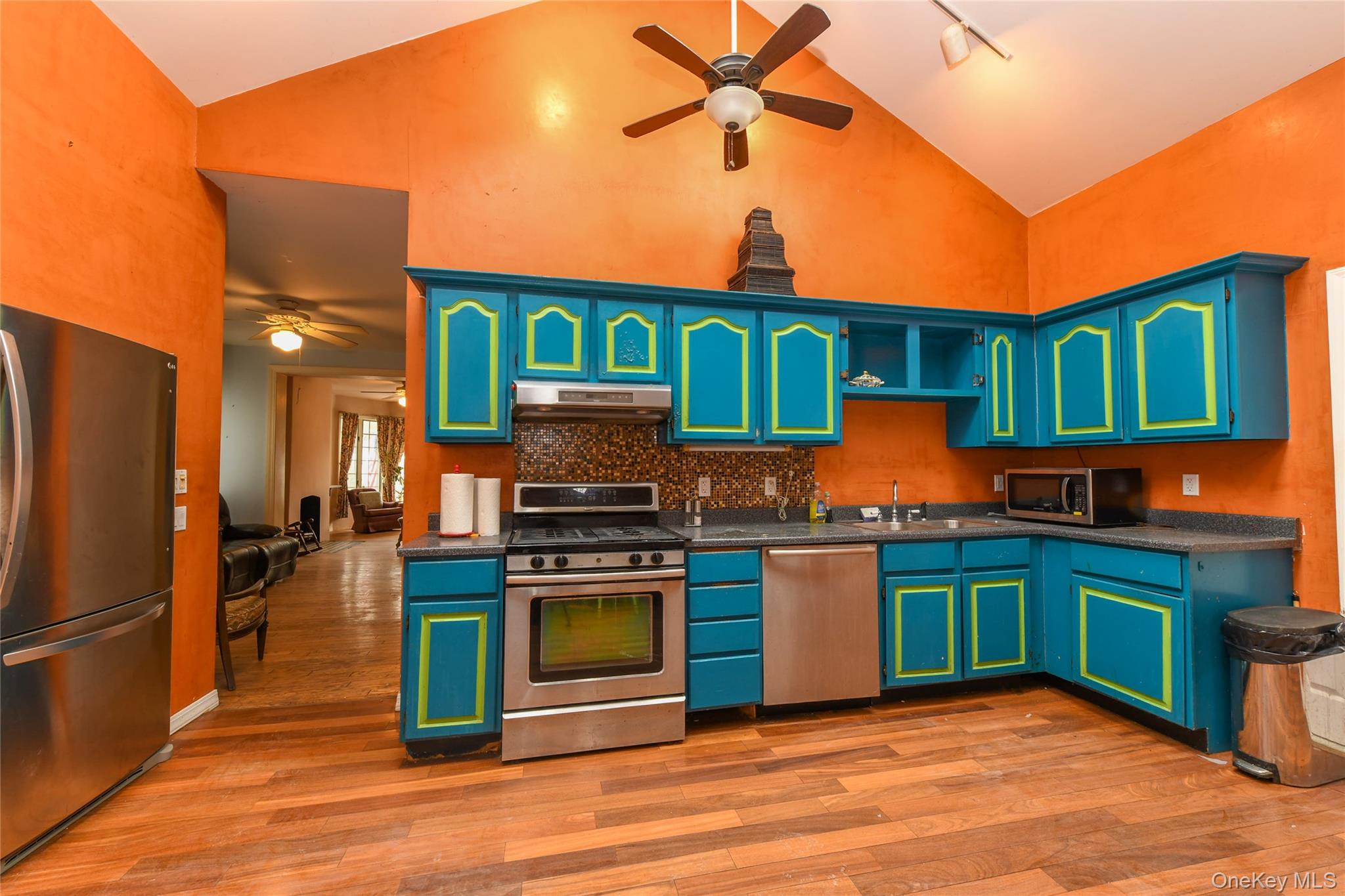 76-43 85th Road Queens, NY 11421 - Photo 19 of 31 a kitchen with stainless steel appliances granite countertop a stove top oven a refrigerator and a sink