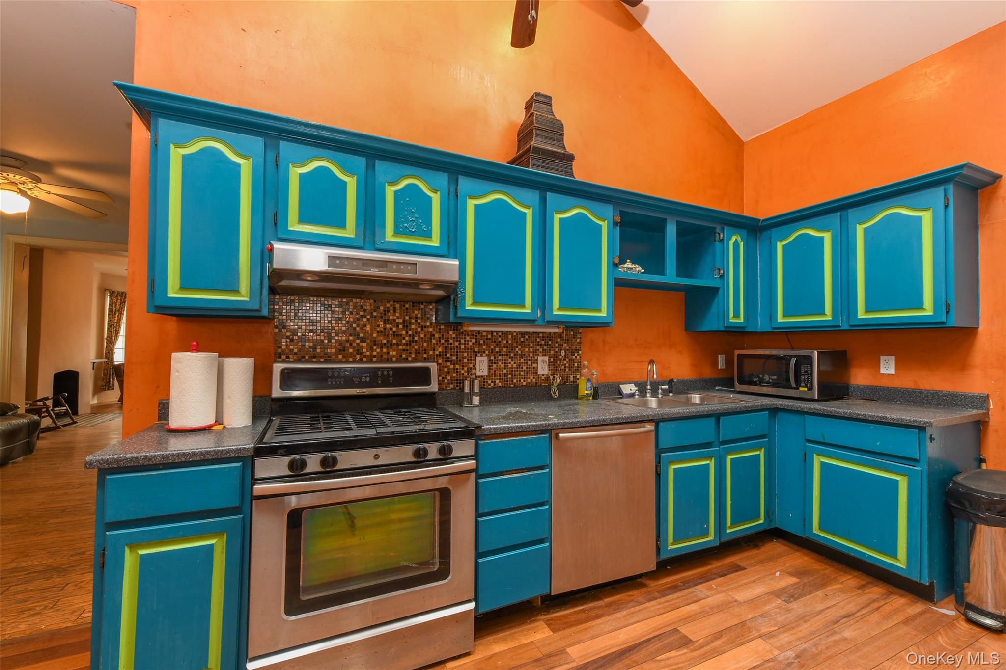 76-43 85th Road Queens, NY 11421 - Photo 20 of 31 a kitchen with granite countertop a stove top oven cabinets and a sink