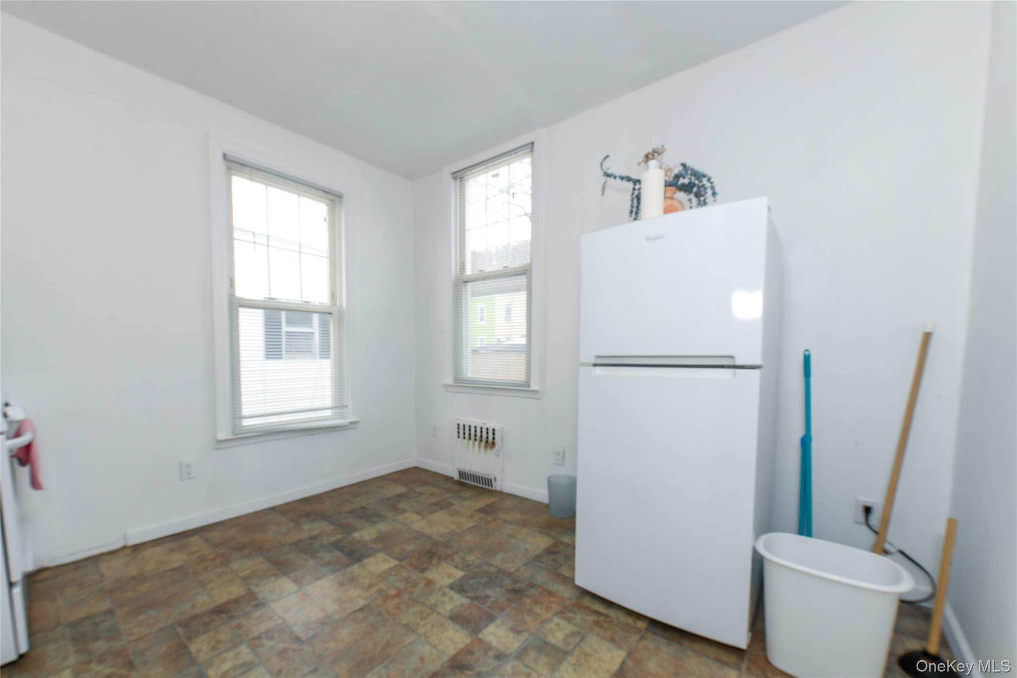 76-43 85th Road Queens, NY 11421 - Photo 24 of 31 a view of kitchen with a refrigerator a washer and dryer