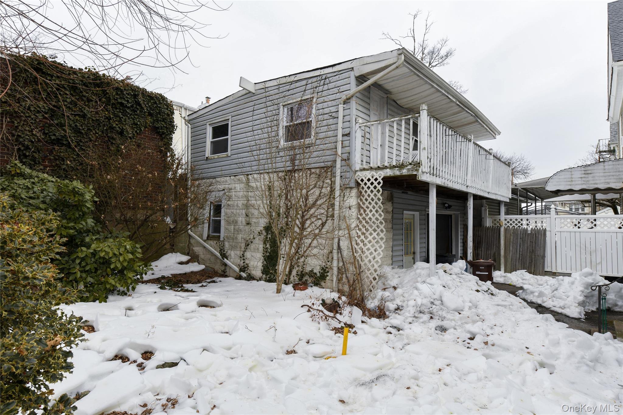 76-43 85th Road Queens, NY 11421 - Photo 4 of 31 a view of a house with a wooden fence