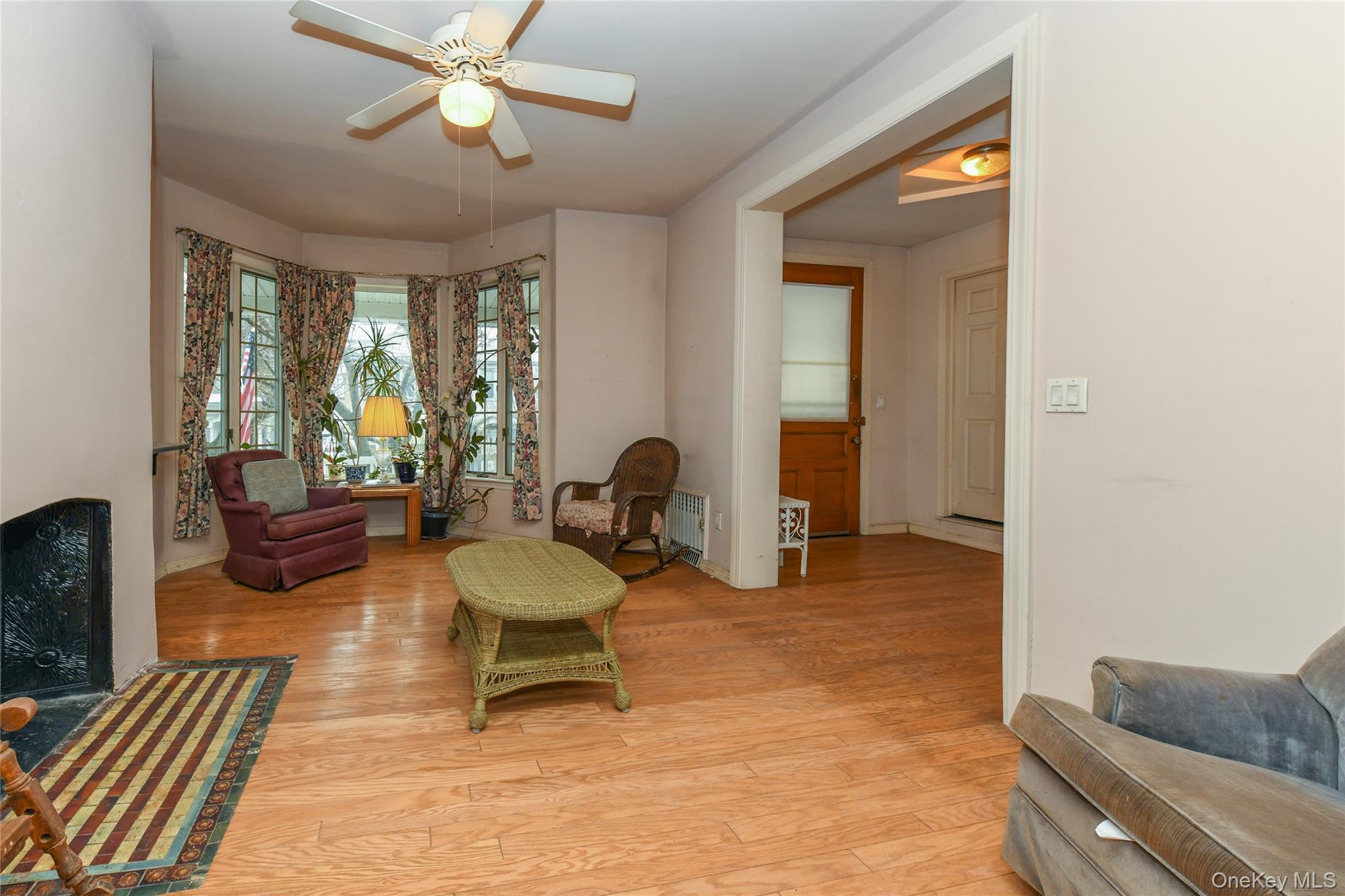 76-43 85th Road Queens, NY 11421 - Photo 8 of 31 a living room with furniture and a chandelier