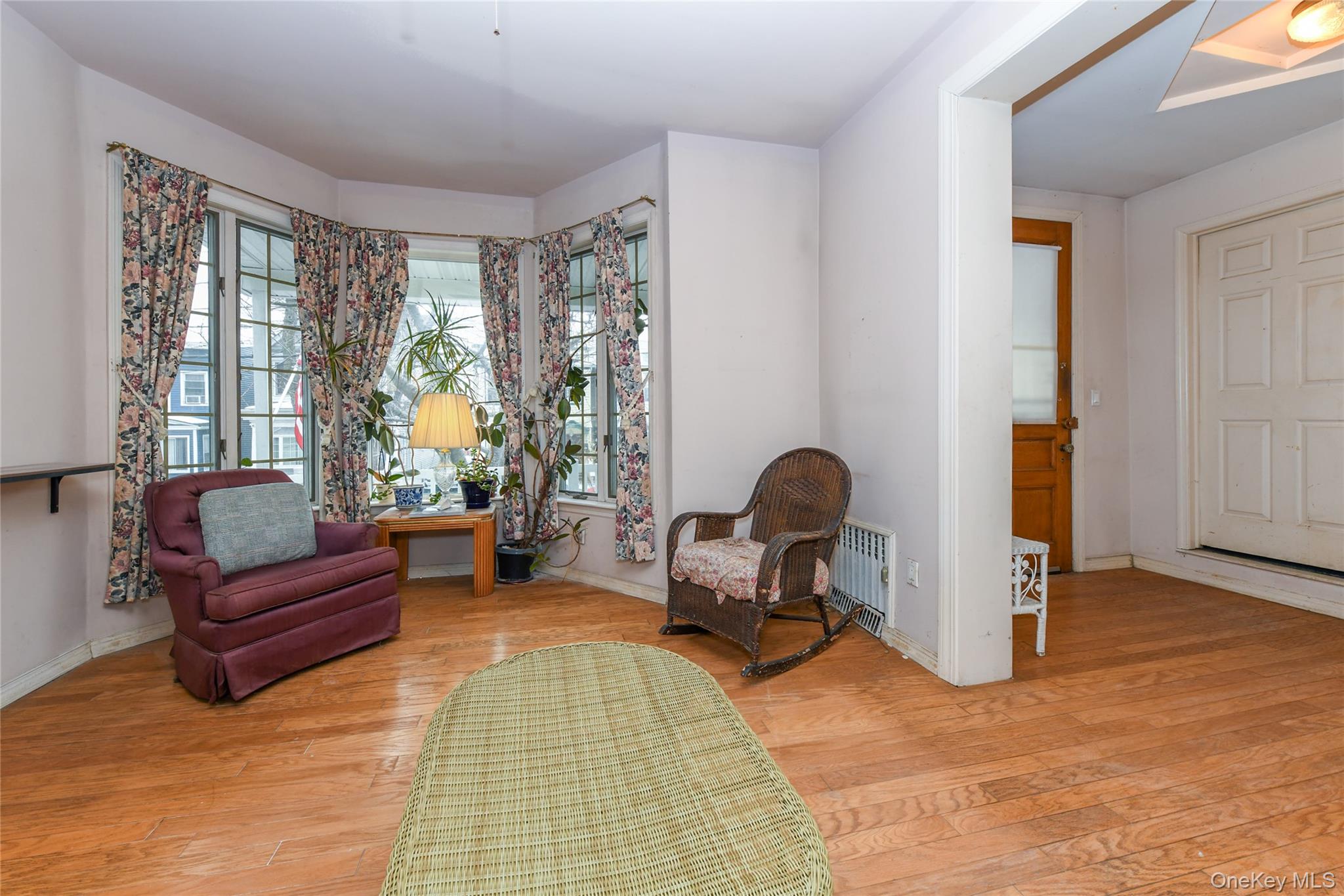 76-43 85th Road Queens, NY 11421 - Photo 9 of 31 a living room with furniture and a window