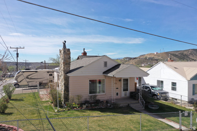 156 D Street Helper, UT 84526 - Photo 4 of 24 Bungalow with a fenced front yard, roof with shingles, and a chimney