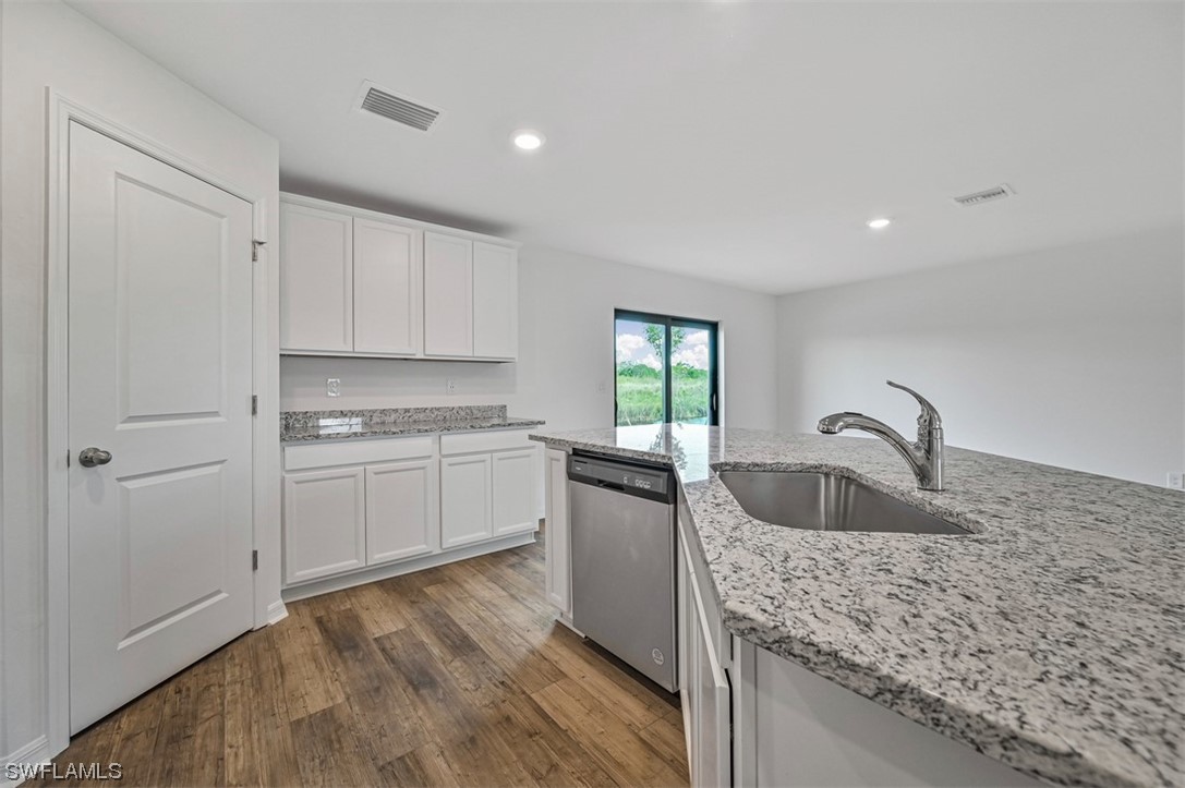 877 General Chesty Puller Court LaBelle, FL 33935 - Photo 9 of 22 a kitchen with granite countertop a sink stove and cabinets