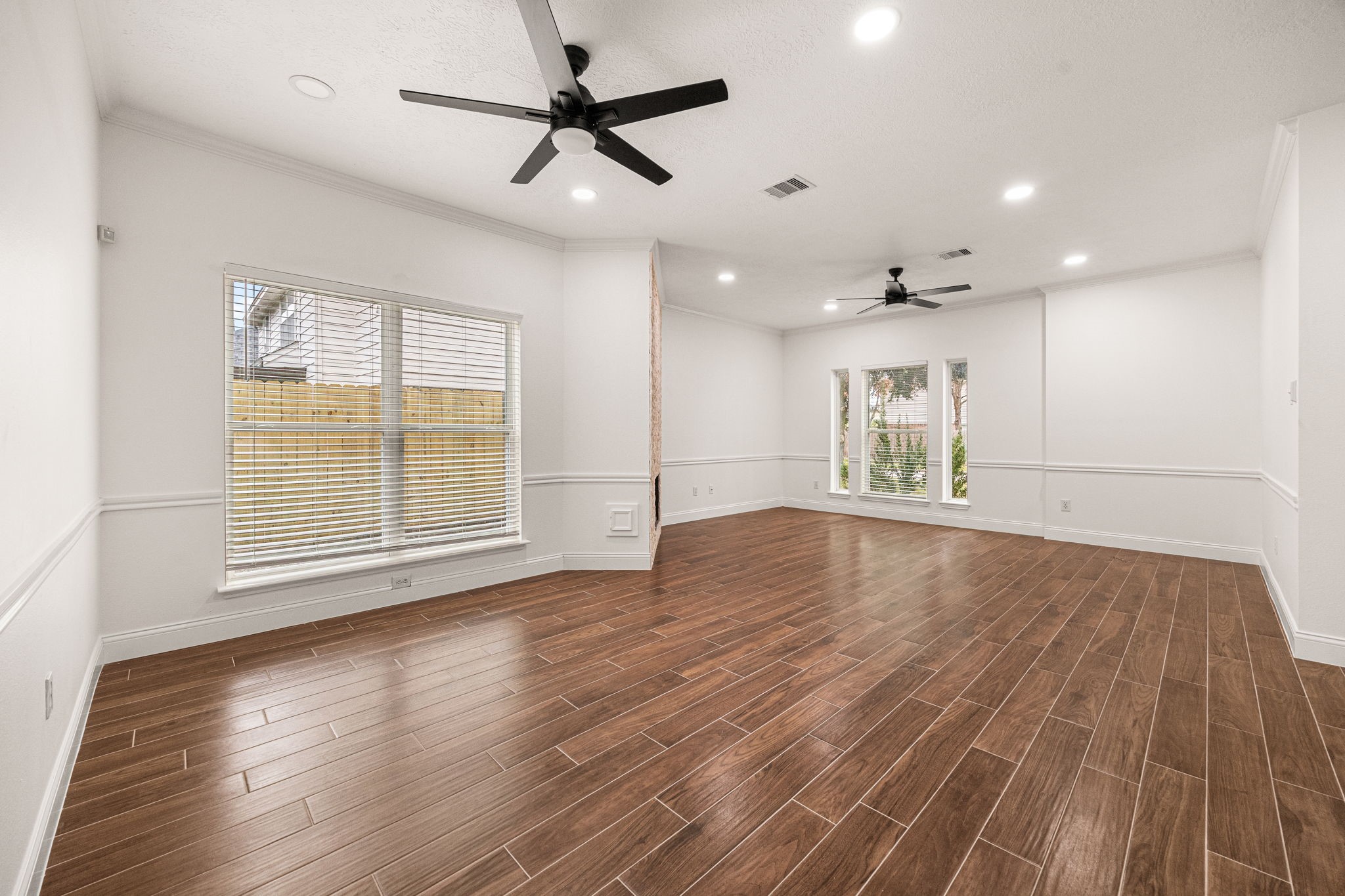 17907 Pelican Way Road Houston, TX 77084 - Photo 11 of 39 a view of an empty room with wooden floor and a window