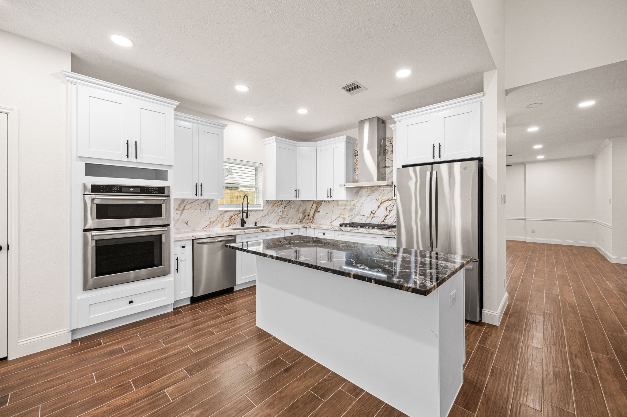 17907 Pelican Way Road Houston, TX 77084 - Photo 13 of 39 a kitchen with kitchen island granite countertop a stove a sink and a refrigerator
