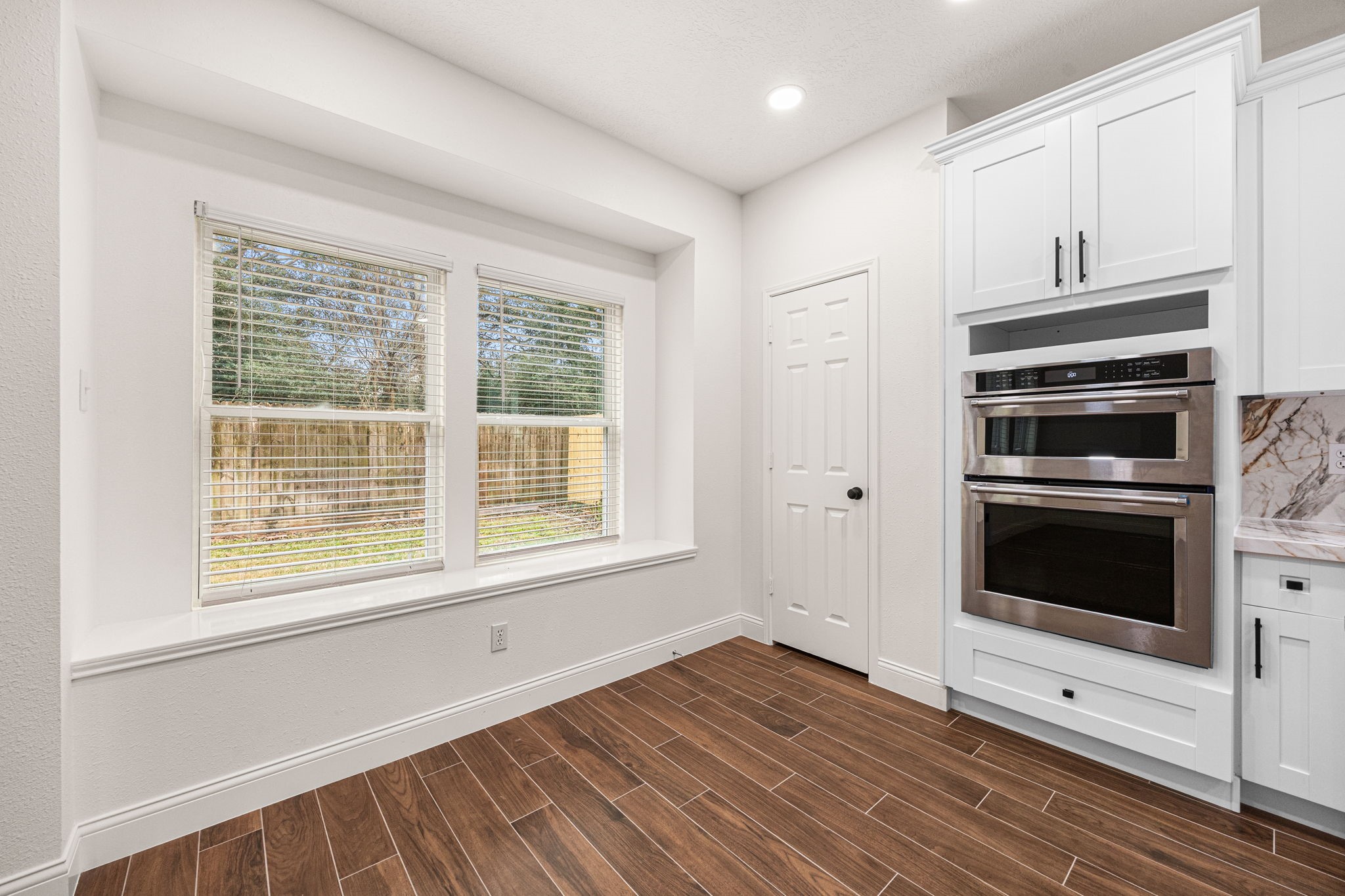 17907 Pelican Way Road Houston, TX 77084 - Photo 19 of 39 a view of a kitchen with wooden floor and electronic appliances