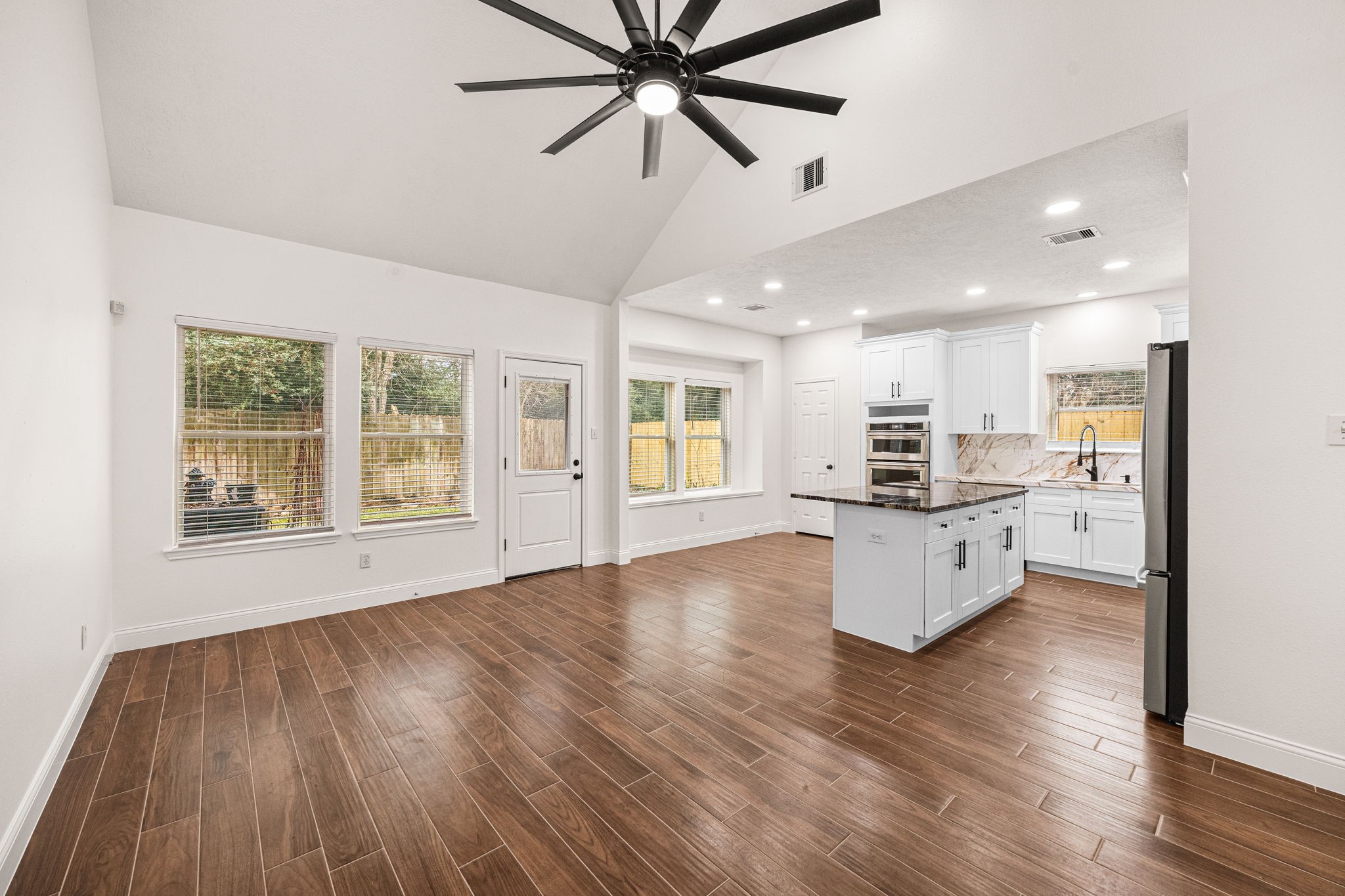 17907 Pelican Way Road Houston, TX 77084 - Photo 21 of 39 a view of kitchen with refrigerator stove and wooden floor