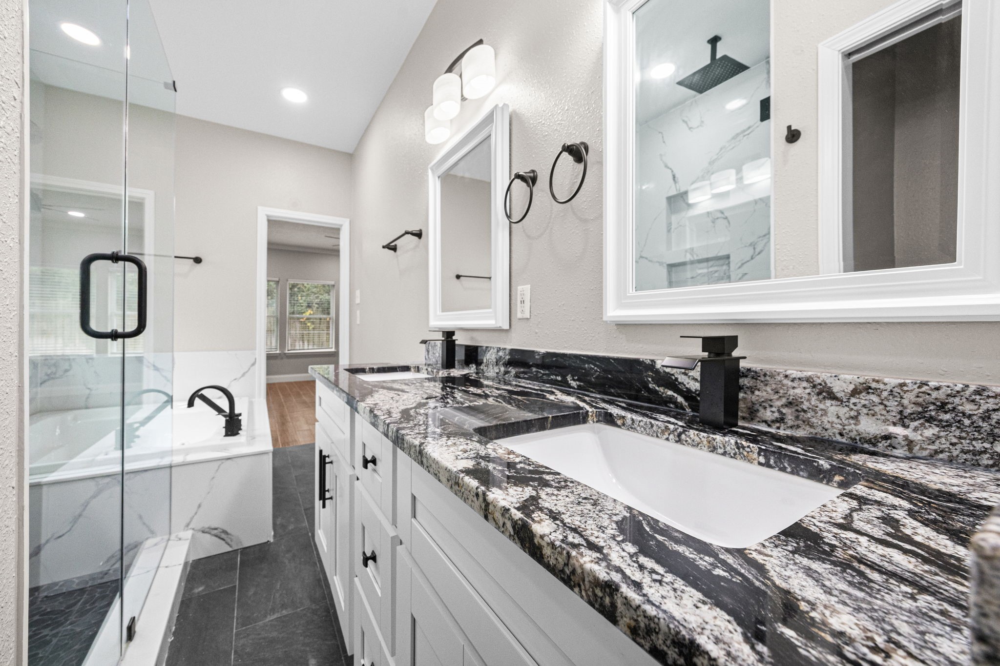 17907 Pelican Way Road Houston, TX 77084 - Photo 27 of 39 a bathroom with a granite countertop sink a mirror and a bathtub