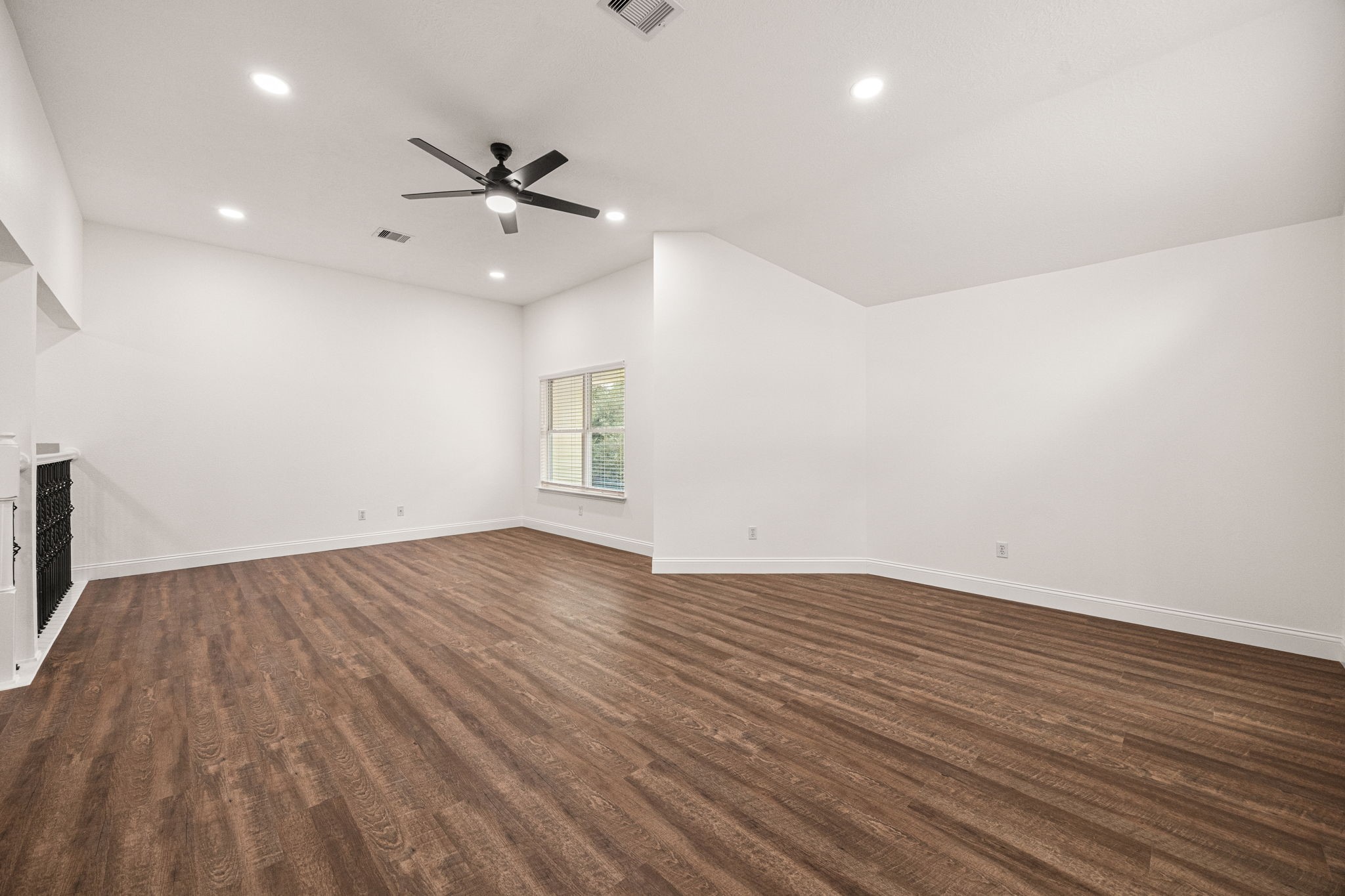 17907 Pelican Way Road Houston, TX 77084 - Photo 29 of 39 an empty room with wooden floor a ceiling fan and windows