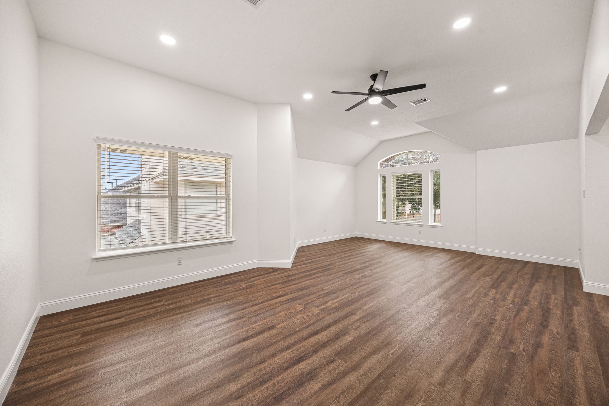 17907 Pelican Way Road Houston, TX 77084 - Photo 30 of 39 an empty room with wooden floor ceiling fan and windows