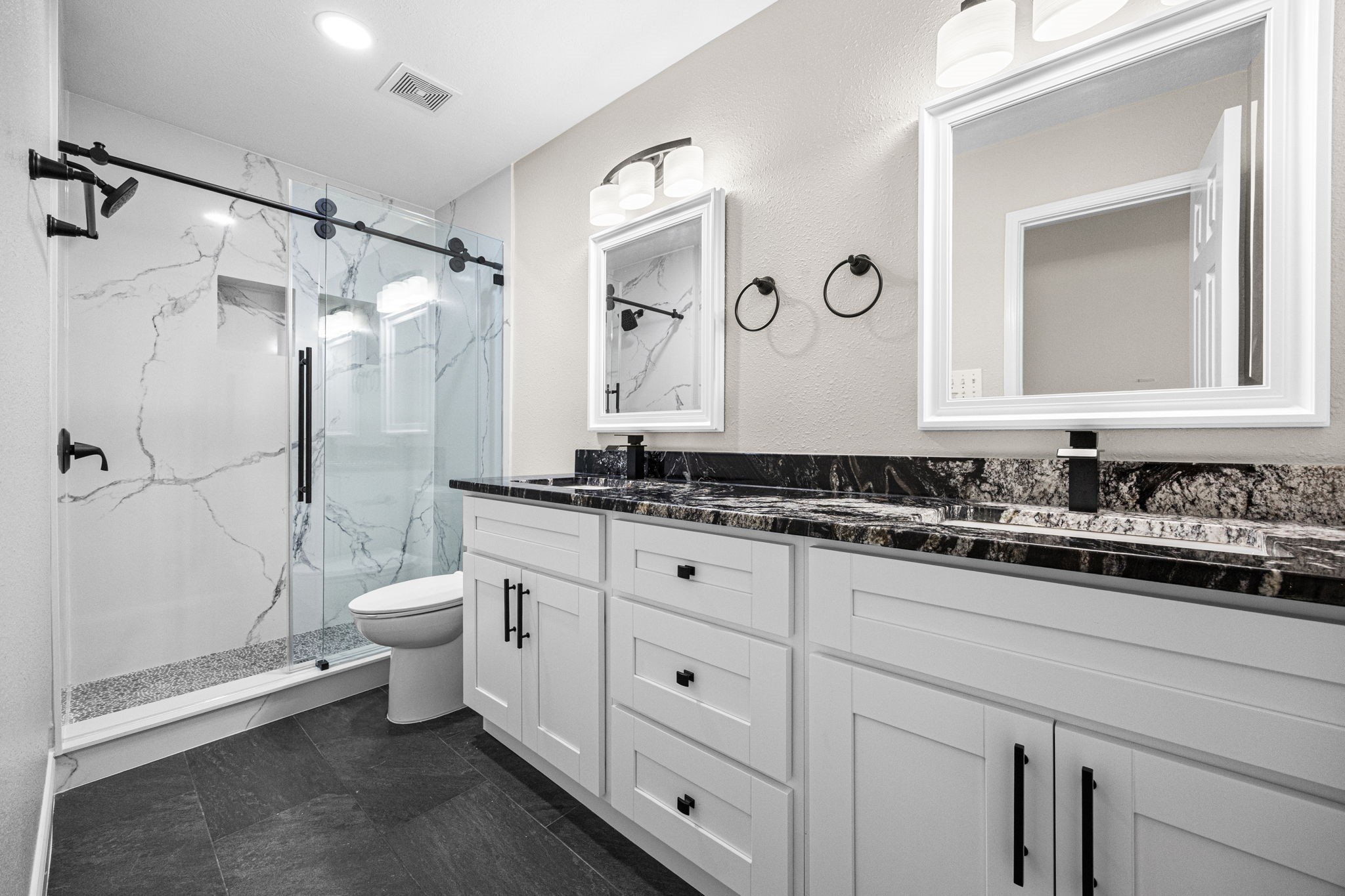 17907 Pelican Way Road Houston, TX 77084 - Photo 34 of 39 a bathroom with a granite countertop sink a toilet and a mirror