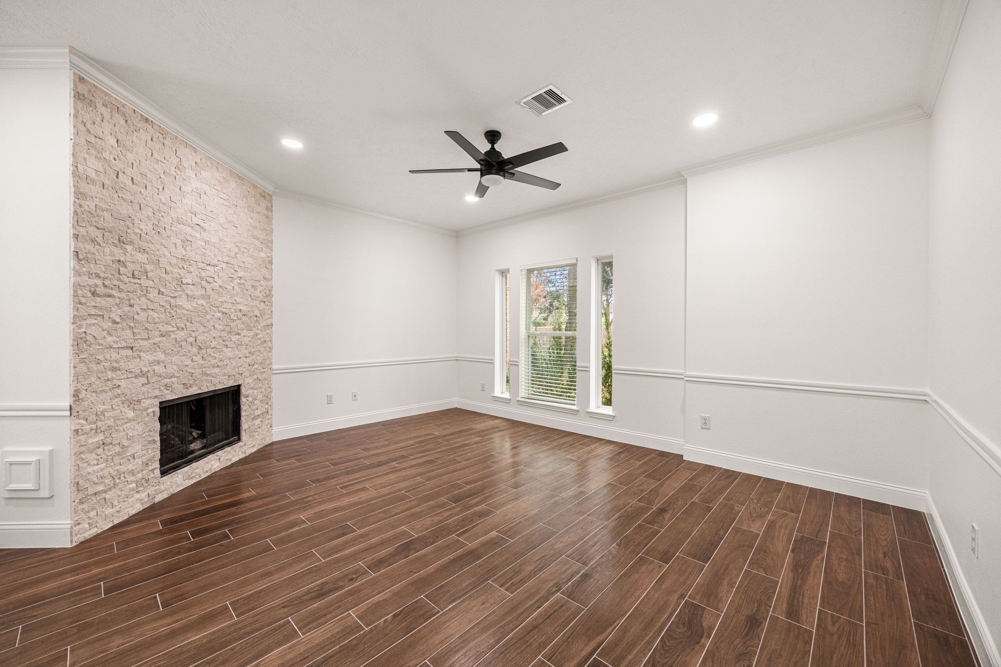 17907 Pelican Way Road Houston, TX 77084 - Photo 7 of 39 a view of empty room with wooden floor and fireplace