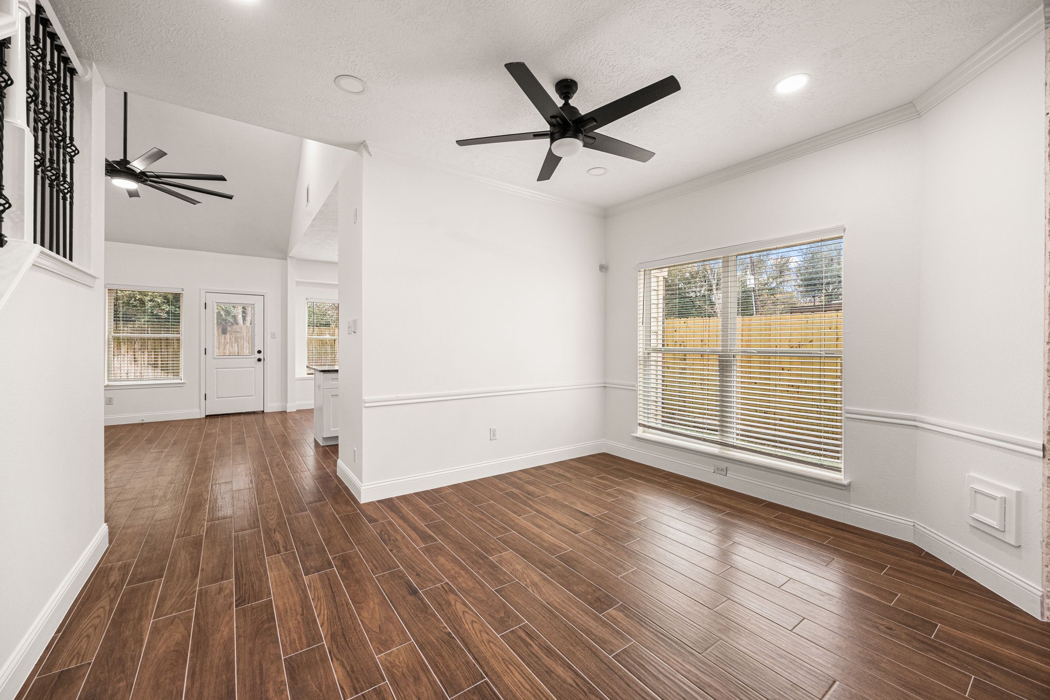 17907 Pelican Way Road Houston, TX 77084 - Photo 10 of 39 an empty room with wooden floor and windows