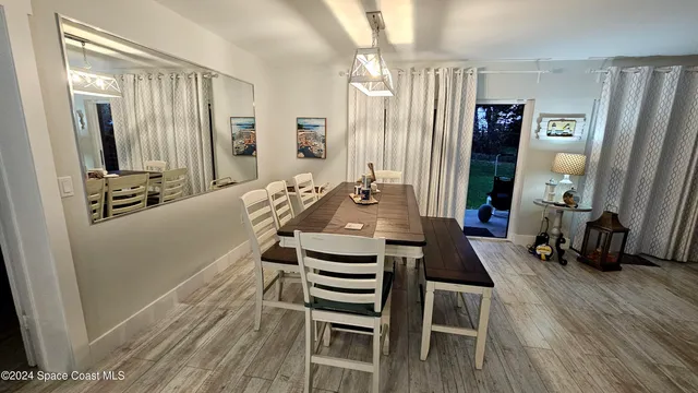 a view of a livingroom with furniture hardwood floor and a window