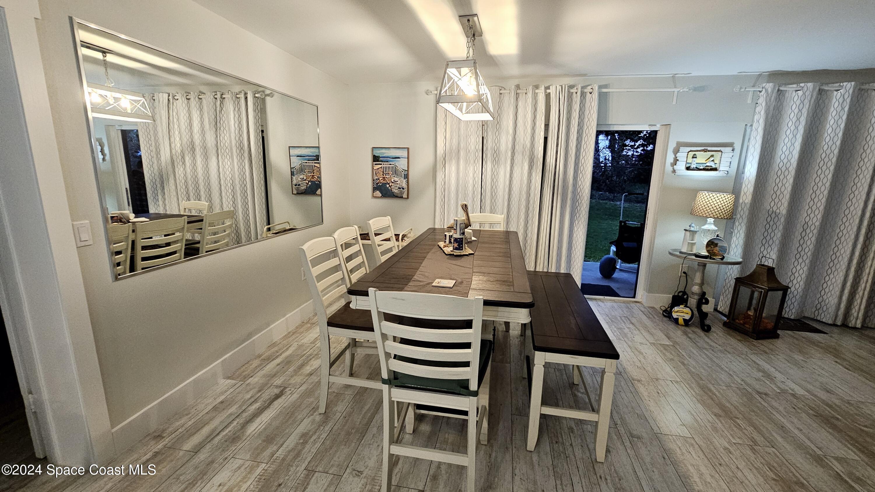 650 North Atlantic Avenue, Unit 109 Cocoa Beach, FL 32931 - Photo 14 of 36 a view of a livingroom with furniture hardwood floor and a window