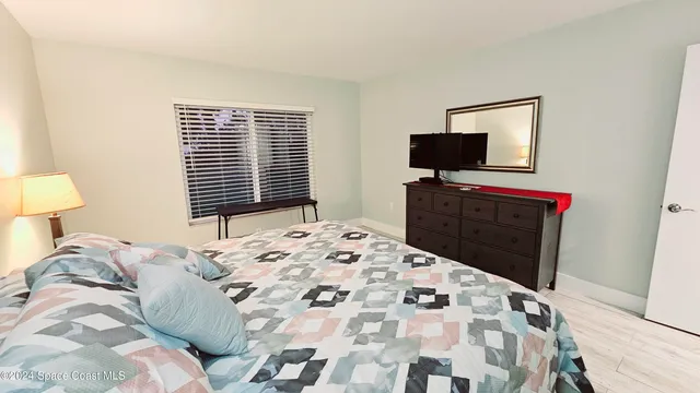 a bedroom with a bed and a television