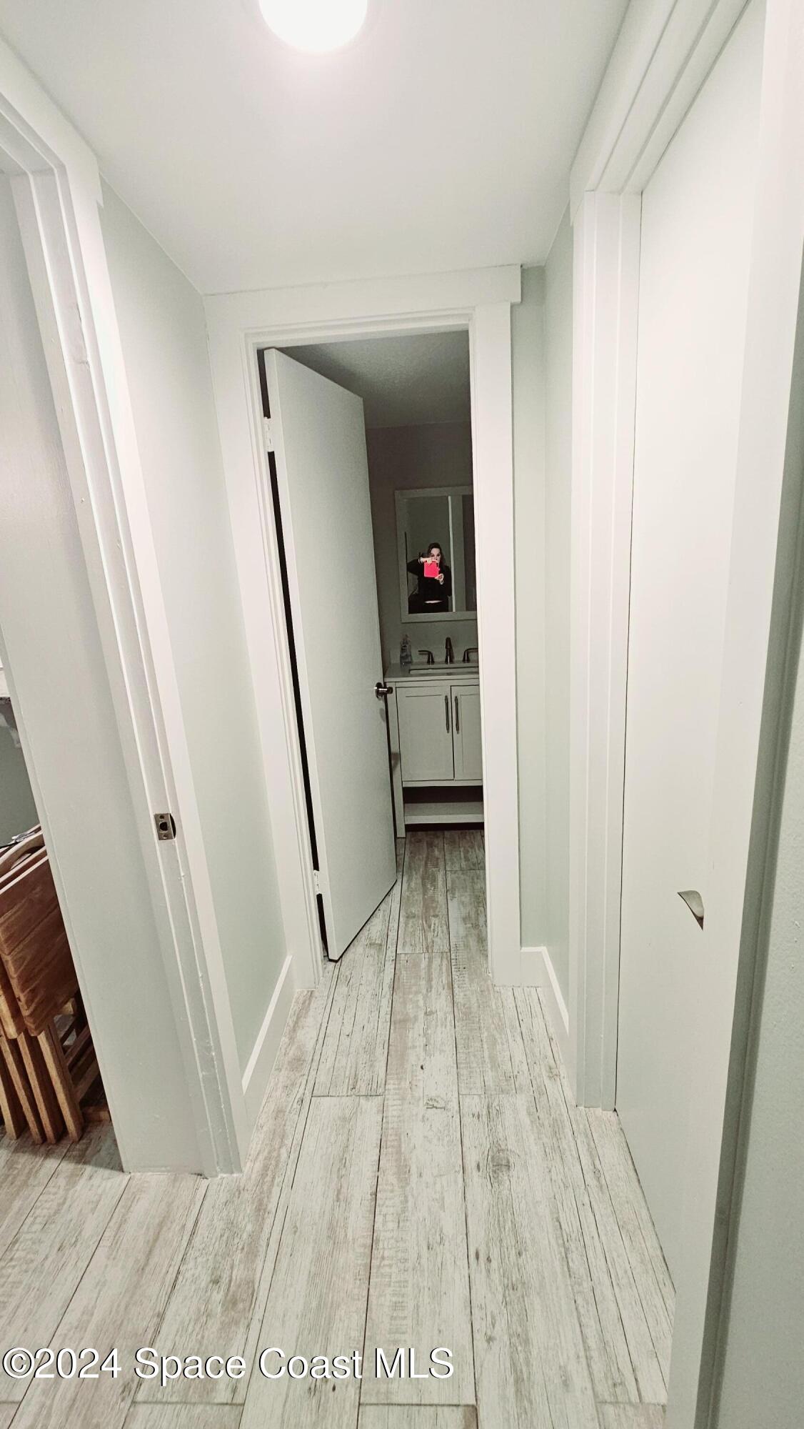 650 North Atlantic Avenue, Unit 109 Cocoa Beach, FL 32931 - Photo 19 of 36 a view of a hallway and a livingroom with furniture