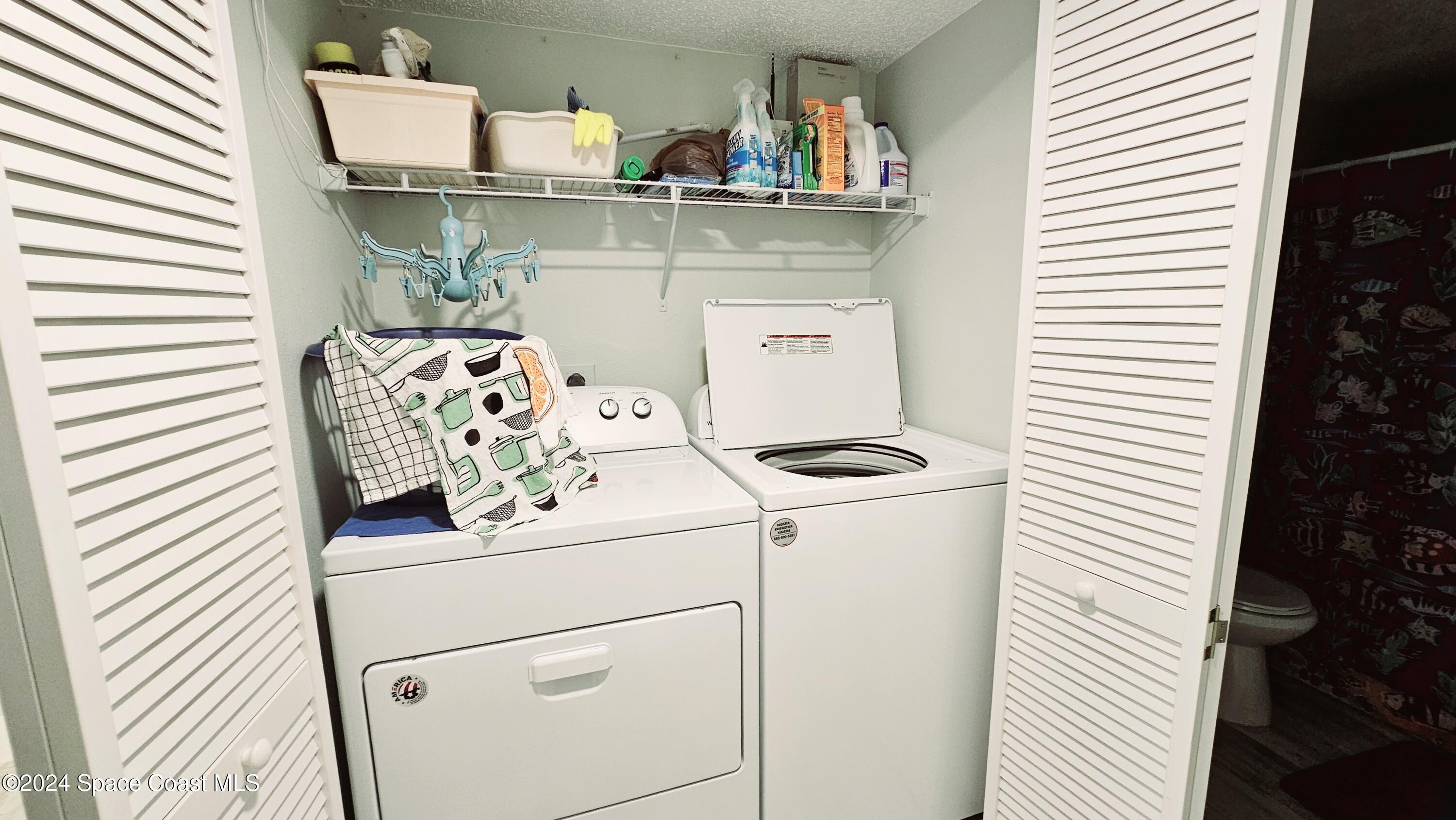 650 North Atlantic Avenue, Unit 109 Cocoa Beach, FL 32931 - Photo 20 of 36 a utility room with dryer and washer