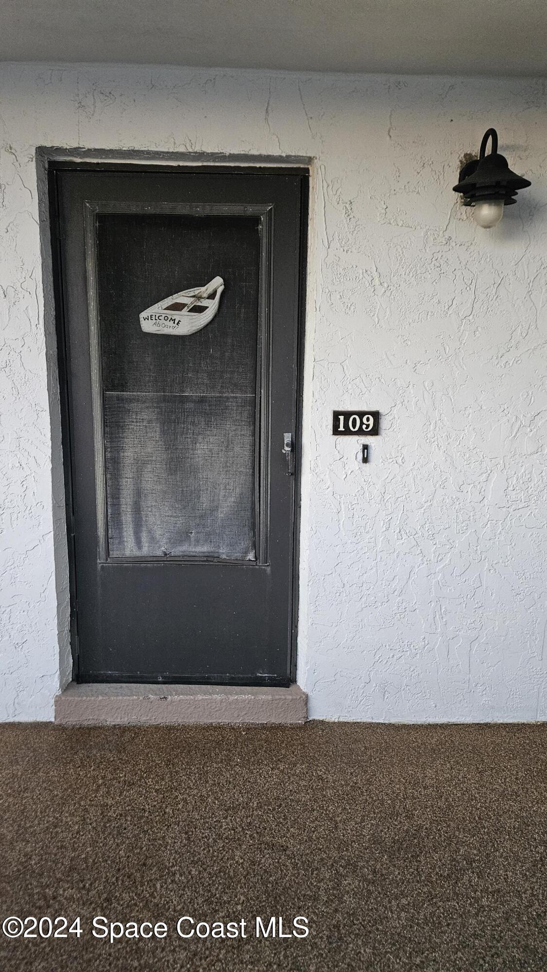 650 North Atlantic Avenue, Unit 109 Cocoa Beach, FL 32931 - Photo 2 of 36 a view of wooden door