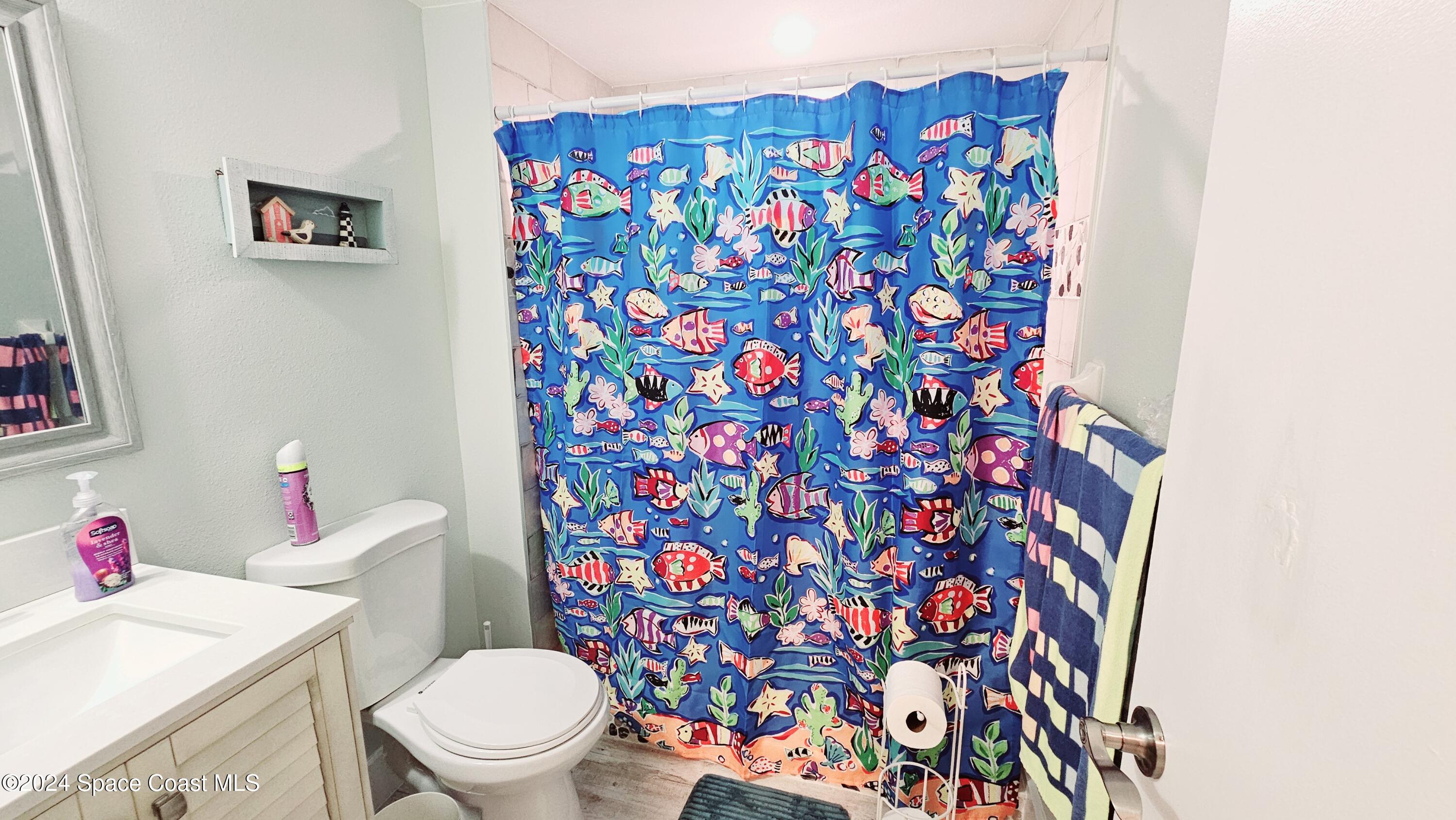 650 North Atlantic Avenue, Unit 109 Cocoa Beach, FL 32931 - Photo 22 of 36 a white toilet sitting next to a sink