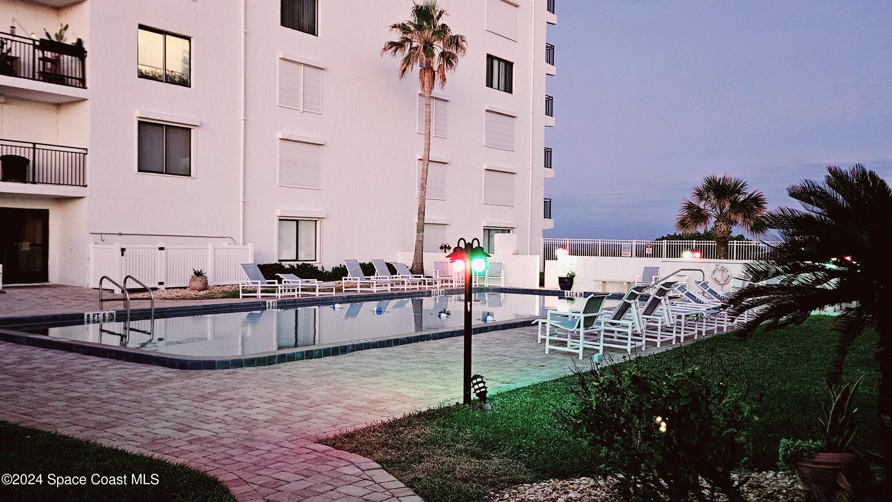 650 North Atlantic Avenue, Unit 109 Cocoa Beach, FL 32931 - Photo 30 of 36 a view of swimming pool with outdoor seating and plants