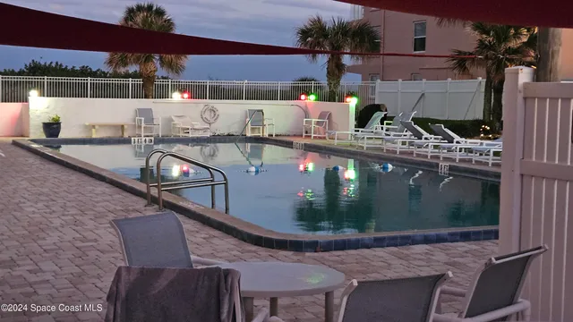 a view of balcony with two chairs and wooden floor