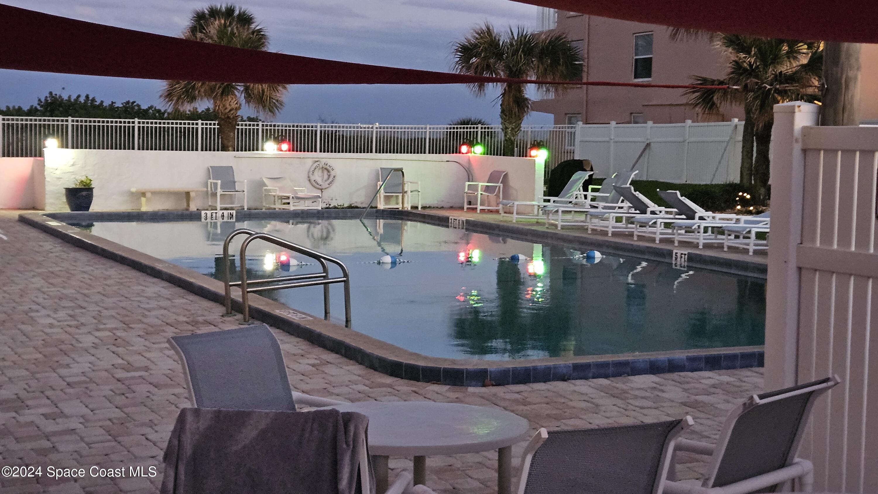 650 North Atlantic Avenue, Unit 109 Cocoa Beach, FL 32931 - Photo 33 of 36 a view of balcony with two chairs and wooden floor