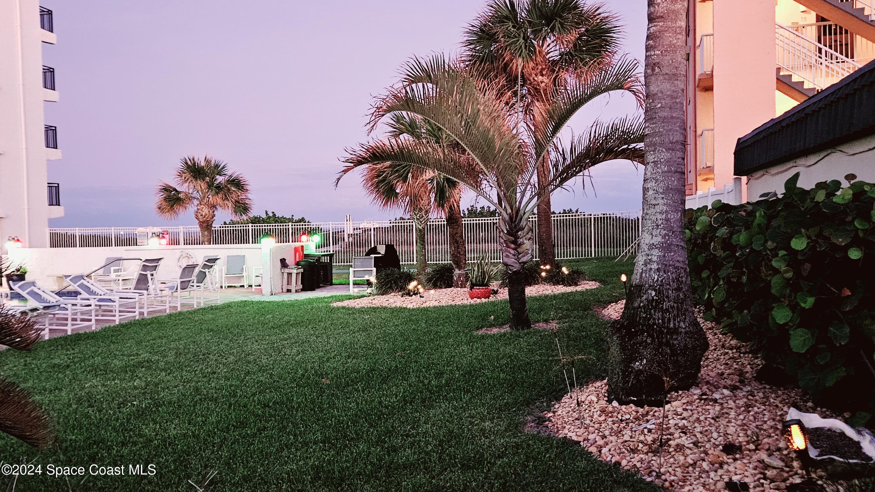 650 North Atlantic Avenue, Unit 109 Cocoa Beach, FL 32931 - Photo 35 of 36 a front view of a house with garden