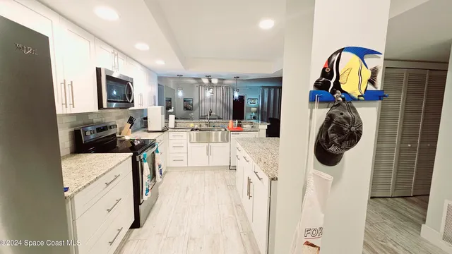 a view of a kitchen with appliances and cabinets