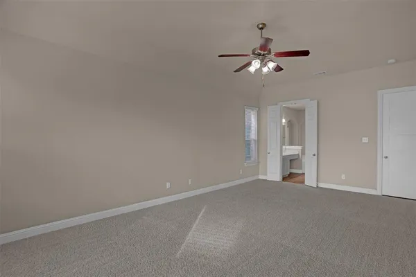 a view of a chandelier fan and fire place