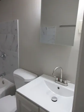 a view of a bathroom from a hallway