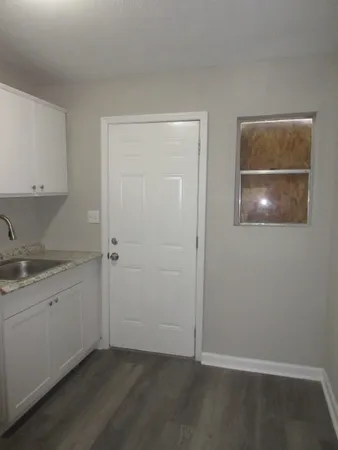 a view of an empty room and wooden floor