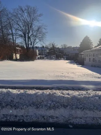 a view of a yard next to a lake