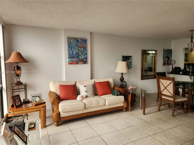 a living room with furniture and floor to ceiling window