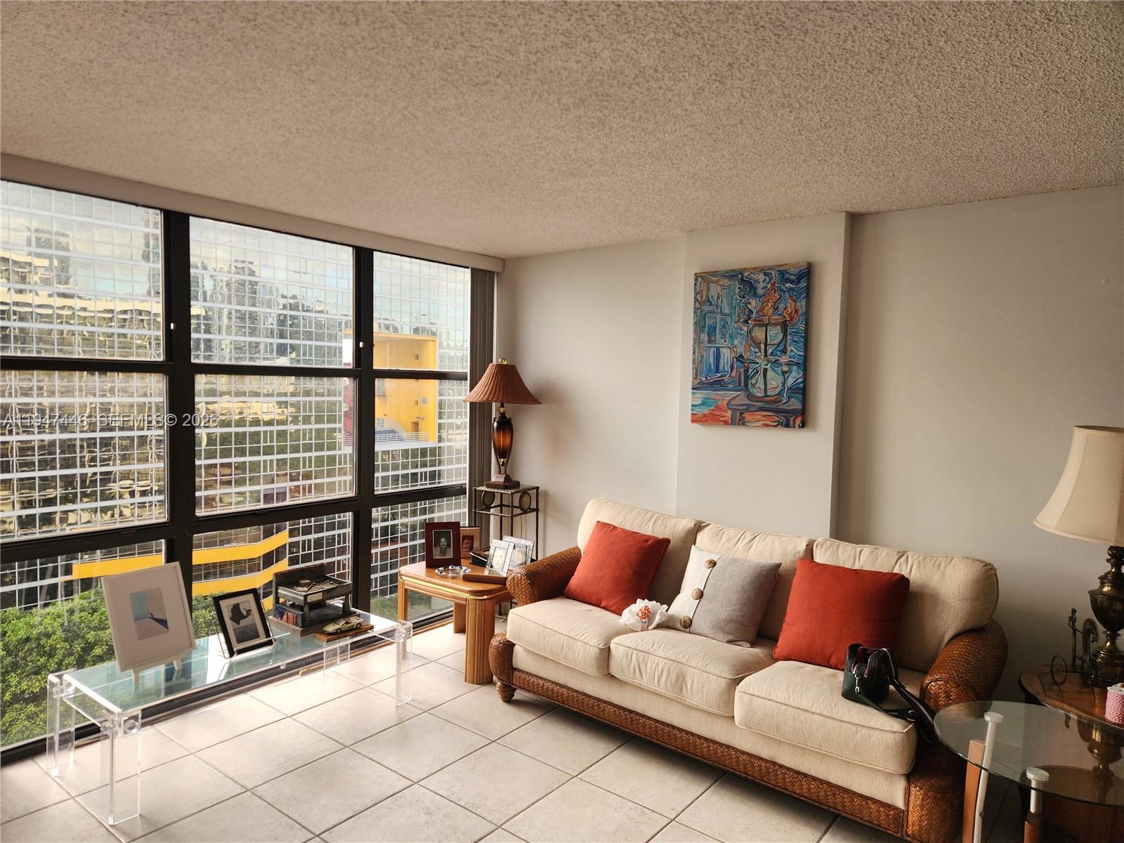 1925 Brickell Avenue, Unit 1411 Miami, FL 33129 - Photo 12 of 52 a living room with furniture and floor to ceiling window